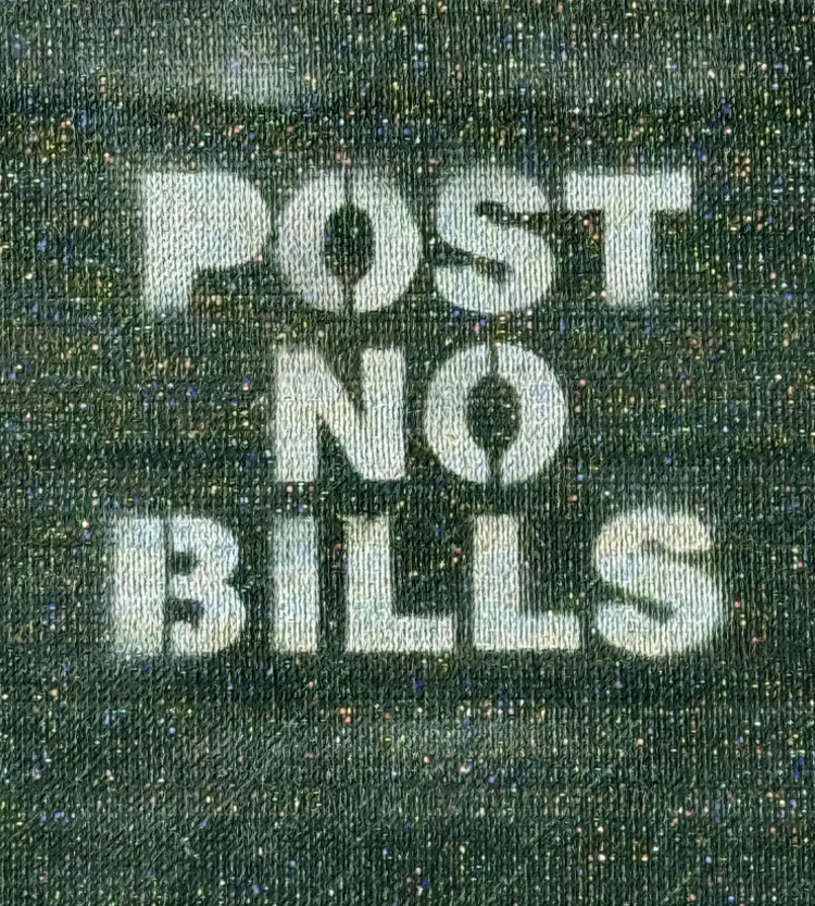 Faded white stencil seen through black construction mesh.